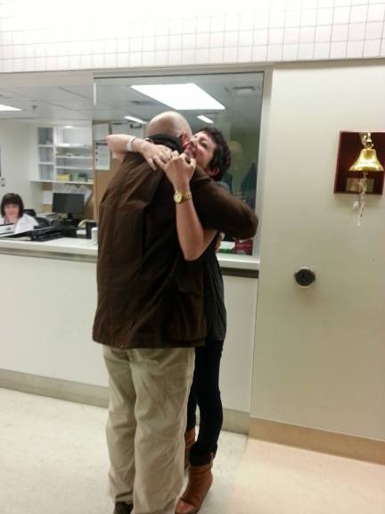 Dad hugs post-bell-ringing